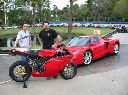 Ducati motorcycle next to a Ferrari Enzo